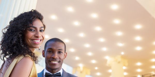 Happy couple dressed formally at an event.