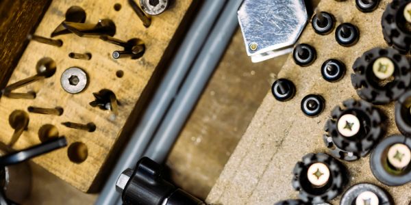 Assortment of drill bits and tools on a workbench.