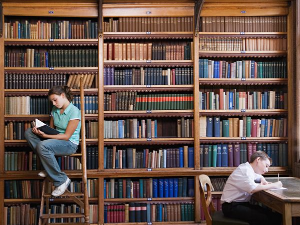 People reading in large library.