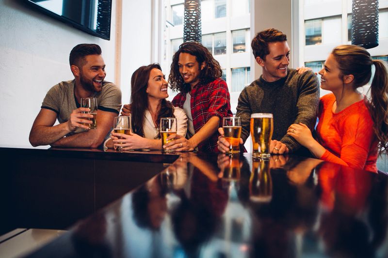 Group of friends enjoying a beer at a bar.