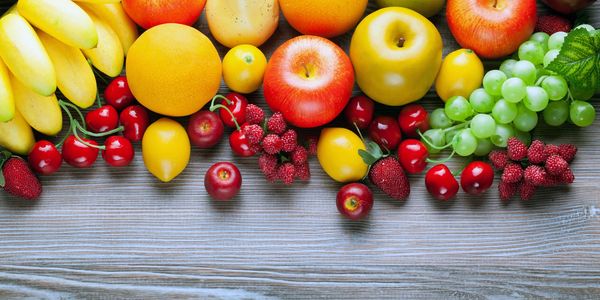 A colorful assortment of fresh fruits on a wooden surface.