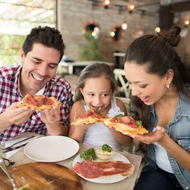 Family enjoying pizza together.