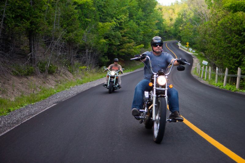 Two friends riding motorcycles on country roadTwo friends riding motorcycles on a twisting country road.