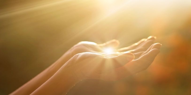 Sunbeam in palm of woman's hand- Alexia Wagner, LMHC Specializing in Life Transitions.
