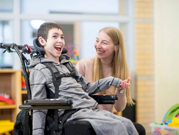 A scenic landscape featuring a sunset over rolling hills with trees silhouetted against the colorful sky.