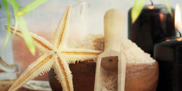 Starfish with bath salts and candles in a spa setting.