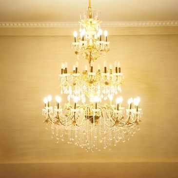 Elegant crystal chandelier with warm glowing lights.