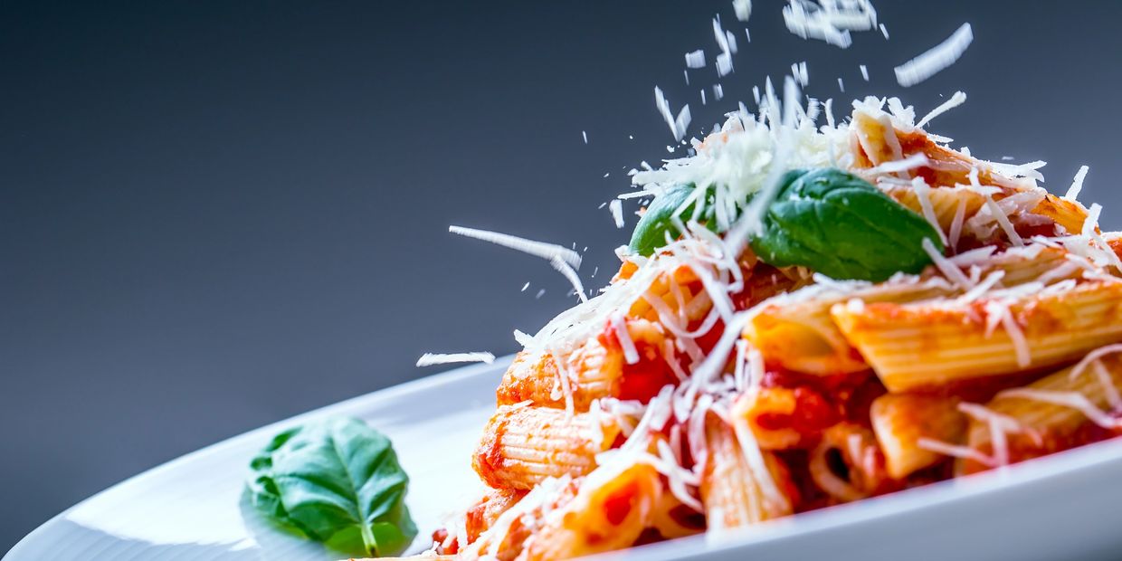 Rigatoni pasta with tomato sauce, basil, and grated cheese