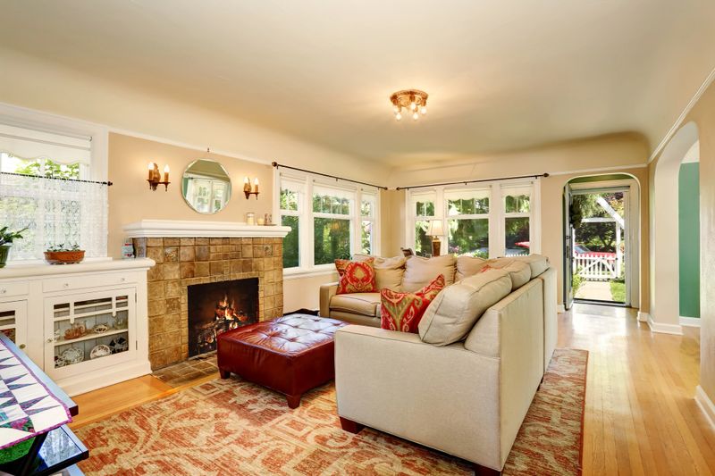 Cozy living room interior with brick fireplace and beige couch. Opened entry door. Northwest, USA