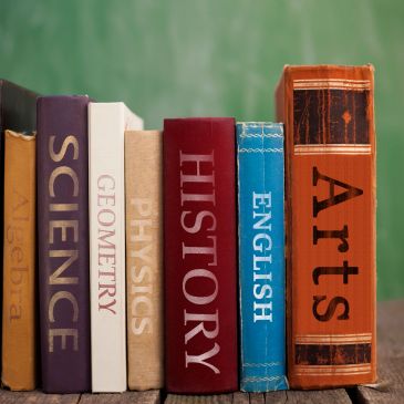 A row of colorful textbooks on various subjects.