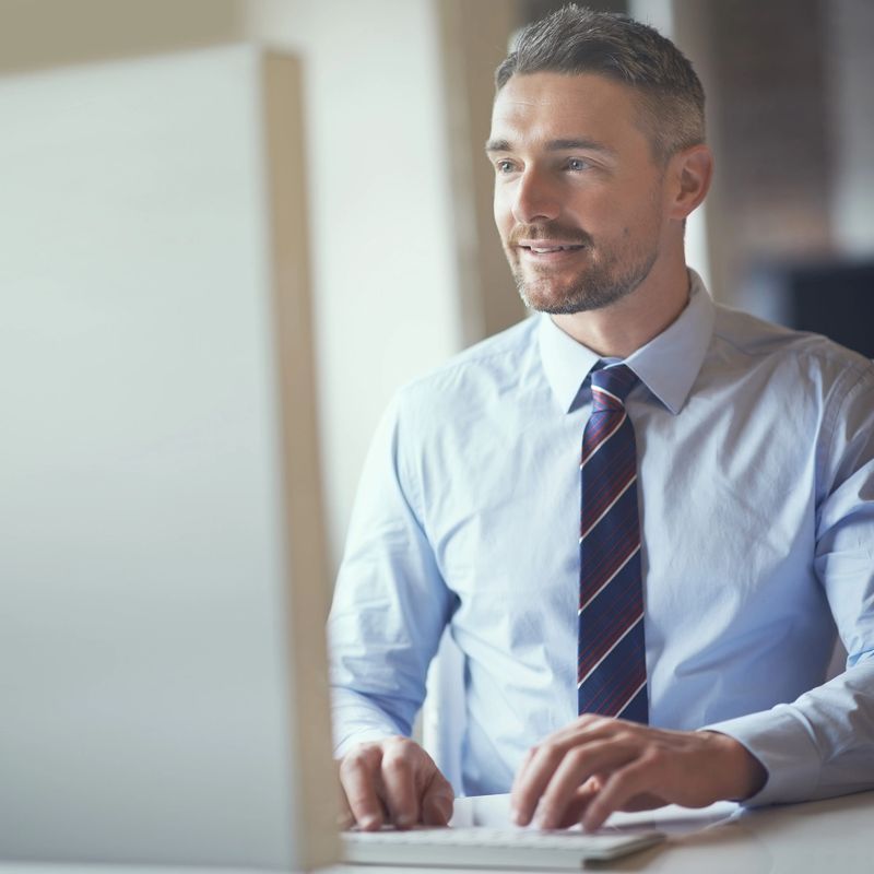 Cropped shot of a businessman working on his computer in an office