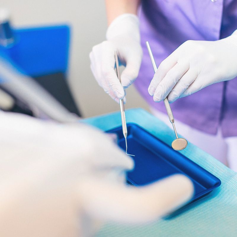 Portraits of doctor and patient in dentist's office. Shallow DOF. Developed from RAW; retouched with special care and attention; Small amount of grain added for best final impression. Adobe RGB color profile.