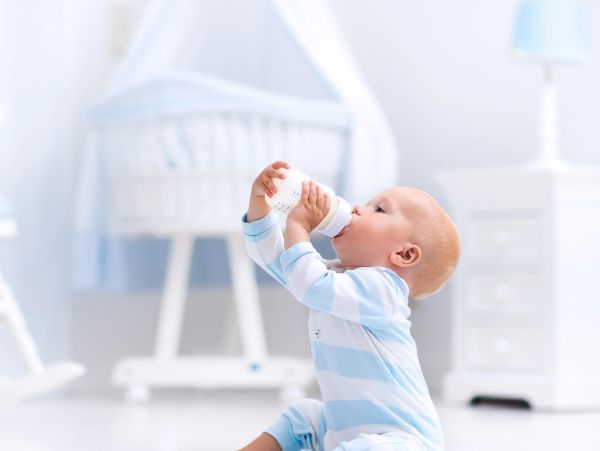 Baby drinking milk from a bottle.