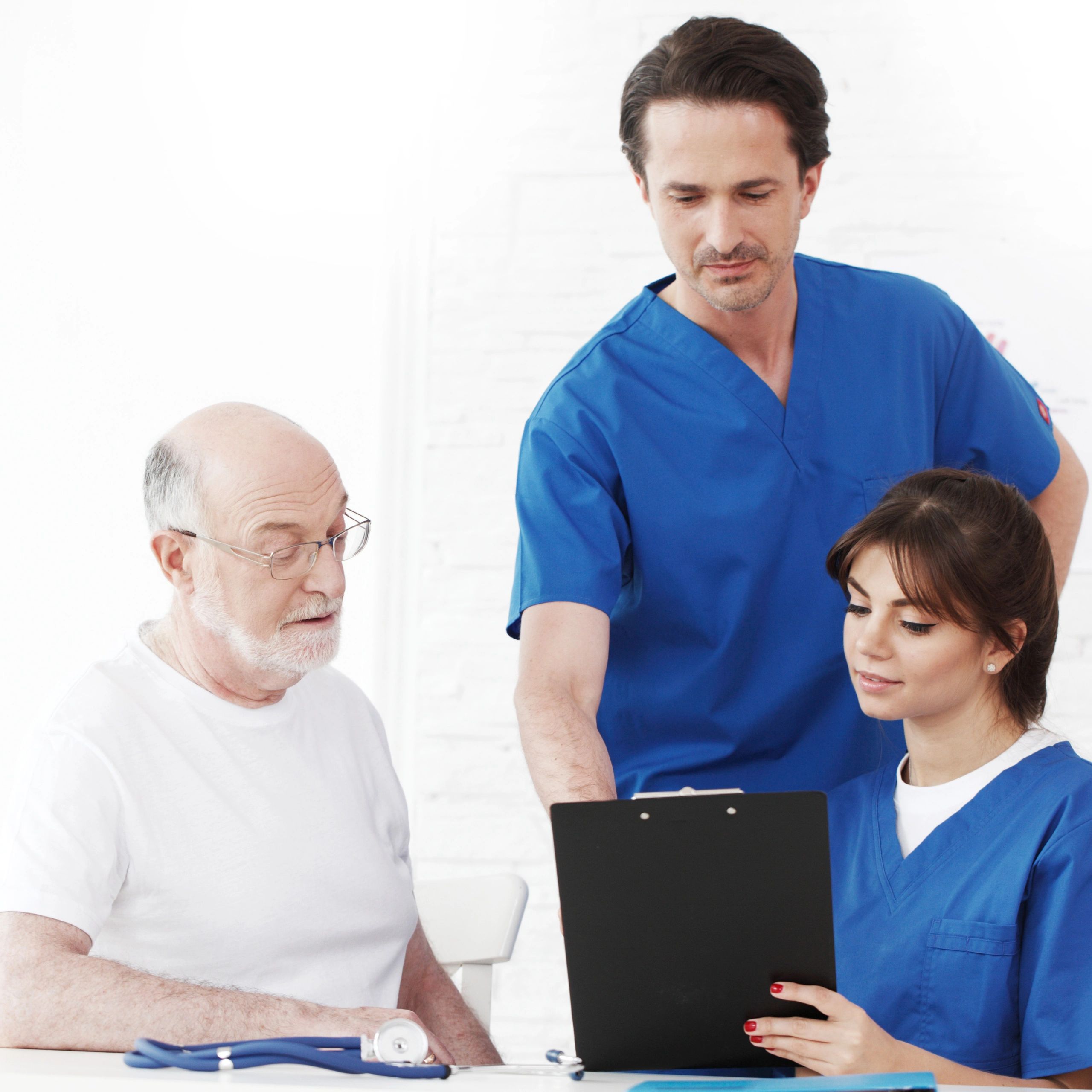 Doctors consulting an elderly patient.
