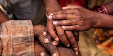 Hands of multiple people showing unity and support.