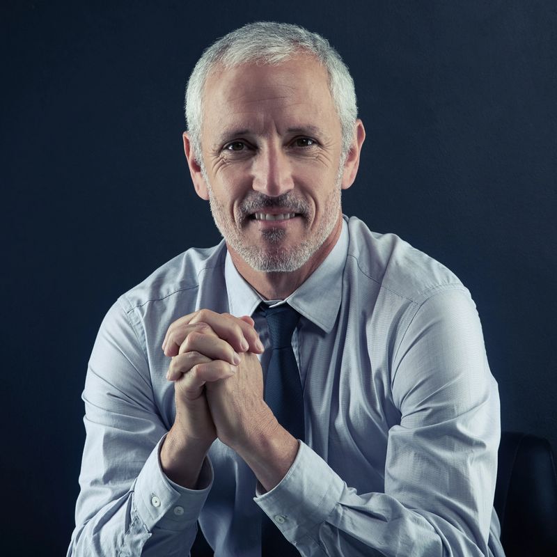Studio portrait of a mature businessman against a dark background