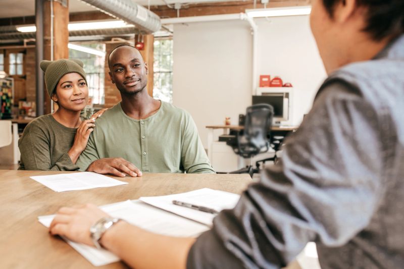 Couple listening insurance agent