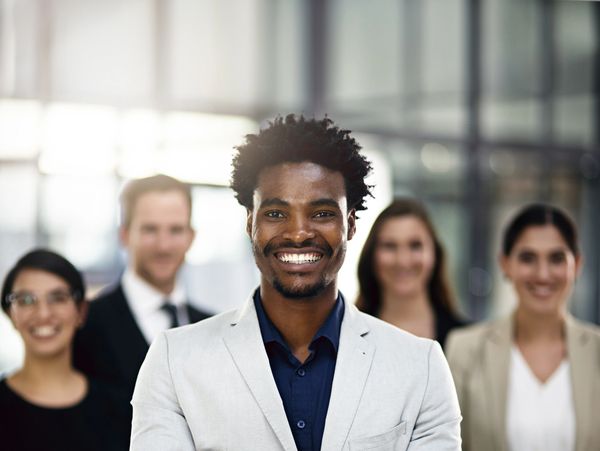 Confident young man leading a diverse professional group.