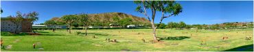 Scenic park with hills and blue sky.
