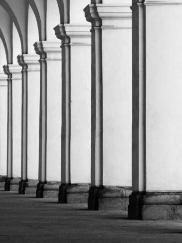 Black and white image of repeated arches and columns.
