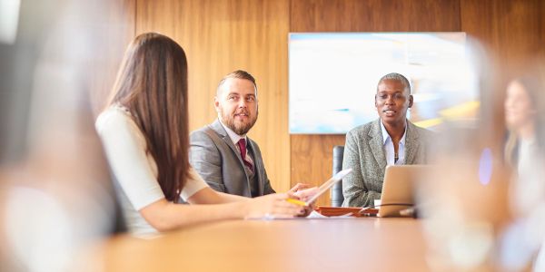 Business meeting with diverse professionals in discussion.