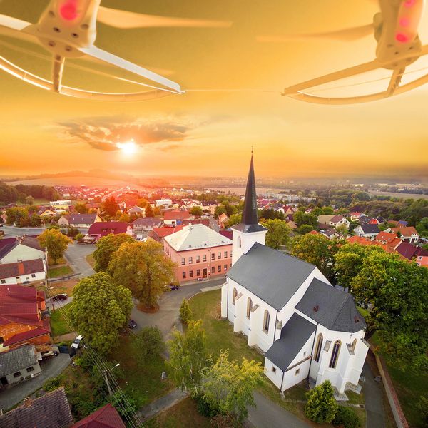 Drone view of a town with a church at sunset.