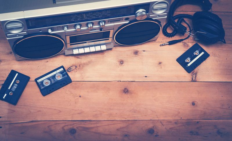 Eighties music hero header with old cassette player and tapes with headset.