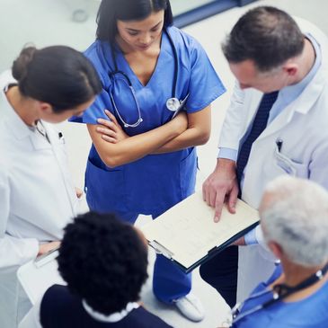 Medical team discussing patient notes.