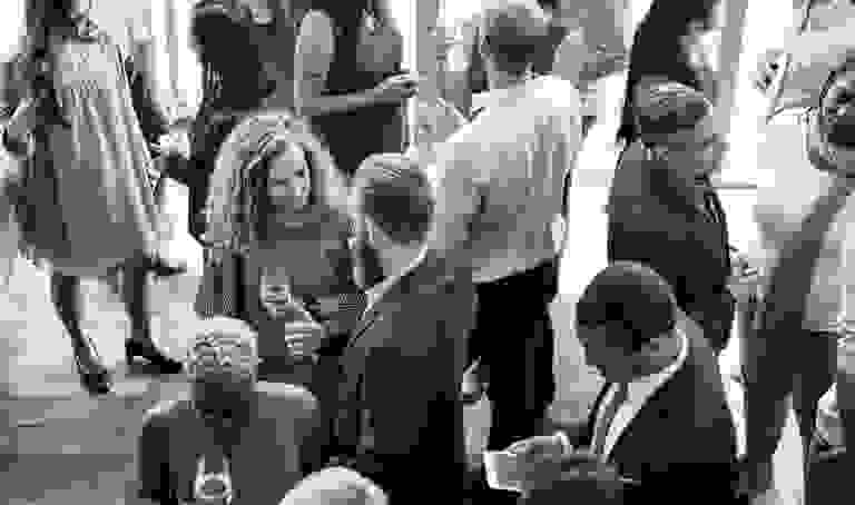 A diverse group of people socializing at a lively indoor event.