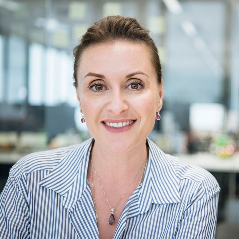 Happy businesswoman at work with striped blouse looking at camera