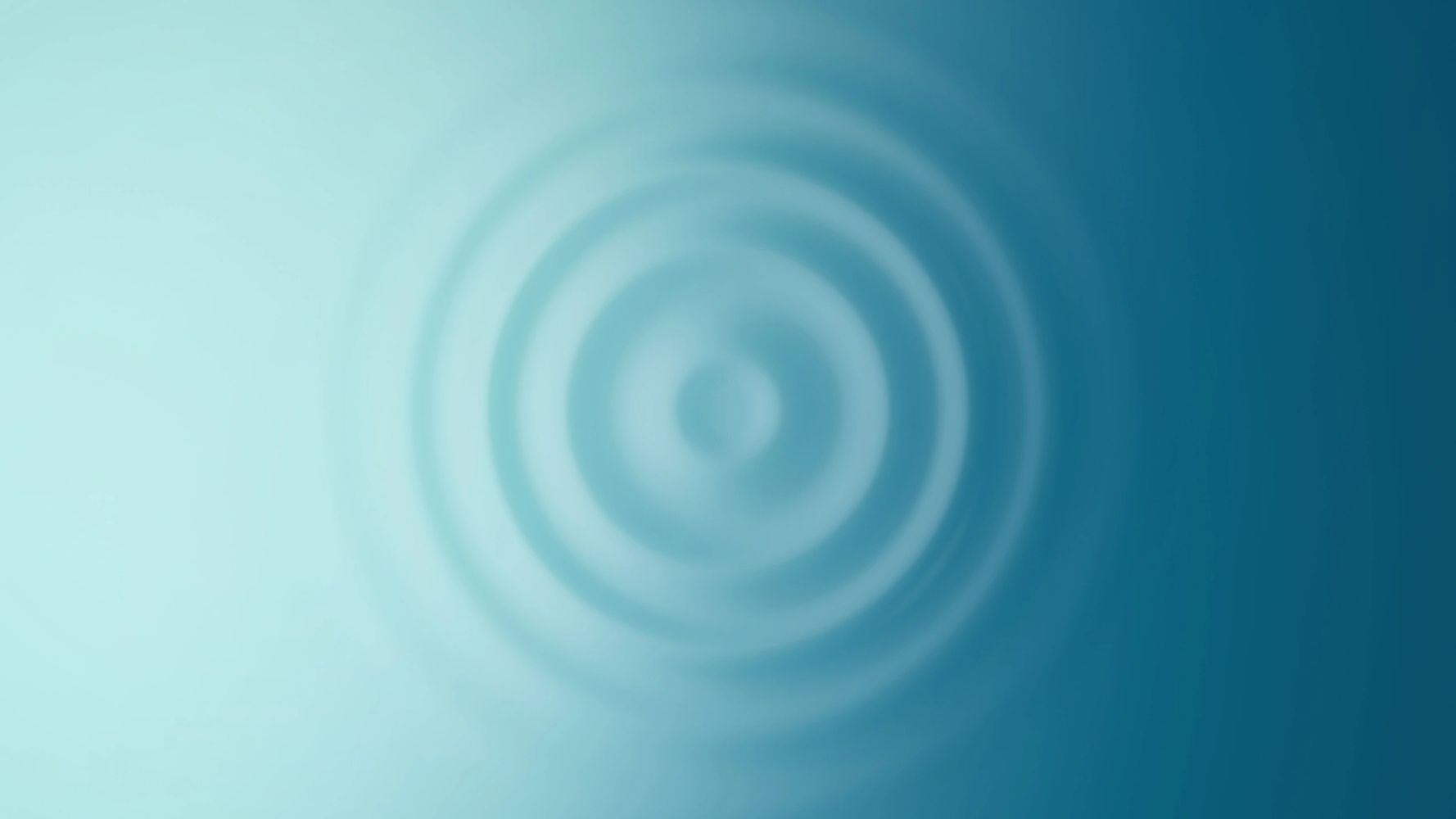 Soft blue concentric circles blur in a gradient background.