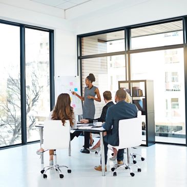 Businesswoman presenting data to colleagues in a modern office.