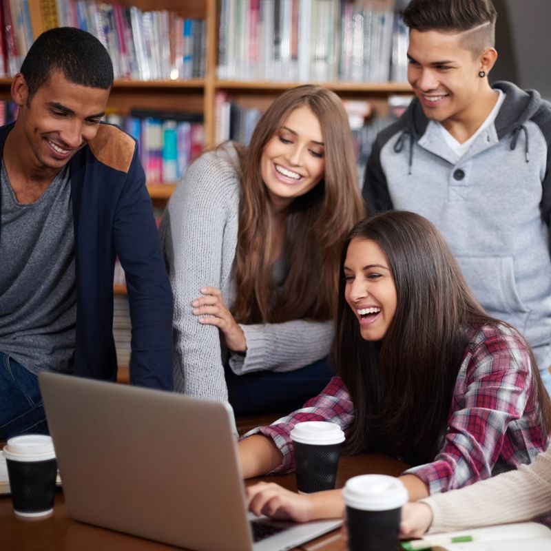 Cropped shot of a group of university students doing a group project in the campus library