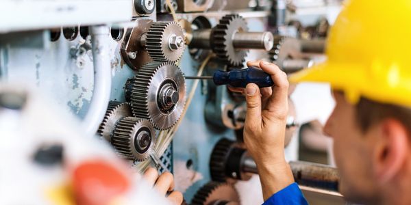 Engineer repairing industrial gears representing urgent oil and gas spare parts delivery Kazakhstan