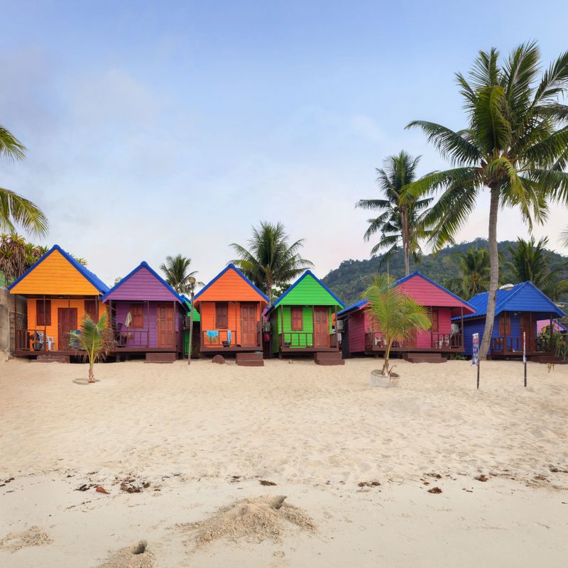 colorful bungalows on the beach. Tropical getaway paradise