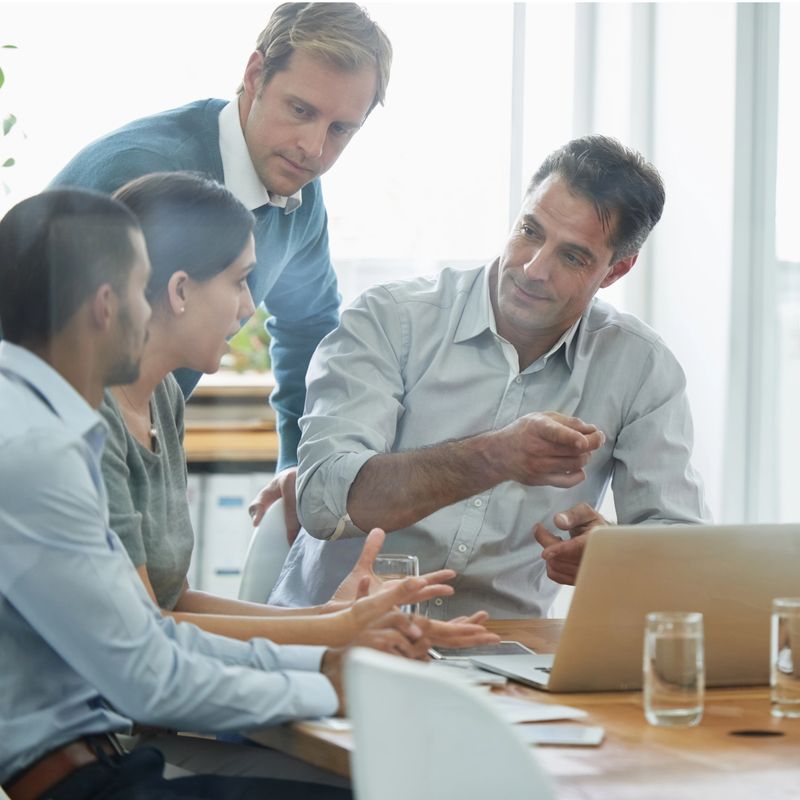 Shot of a group of professionals using wireless technology during a meeting