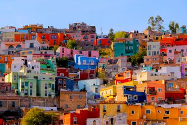Colorful houses densely packed on a hillside under a clear sky.