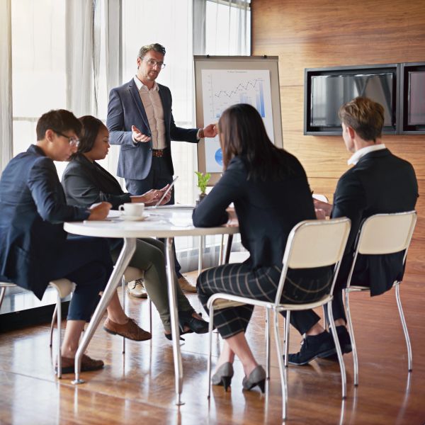 Business team attending a presentation in a modern office setting.