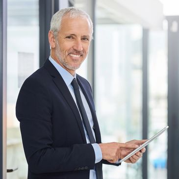 Confident businessman using a tablet in a modern office.