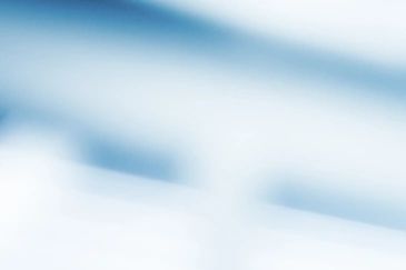 A scenic view of mountains with a clear blue sky and a lush green valley.