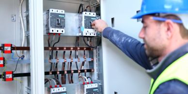 Electrician inspecting circuit breakers.