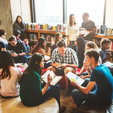 Students studying and discussing in a bright library.