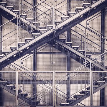 Intricate metal staircases in an industrial setting.