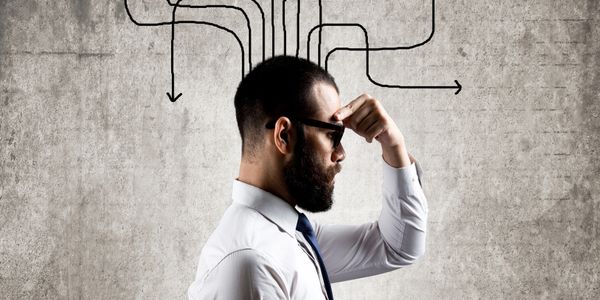 Man in glasses thinking with arrows illustrating decision paths.
