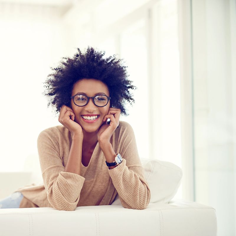 Portrait of a happy young woman relaxing at home