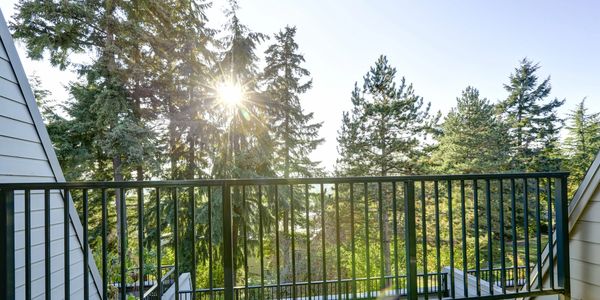 Stunning elevated deck construction with custom wrought iron safety railing