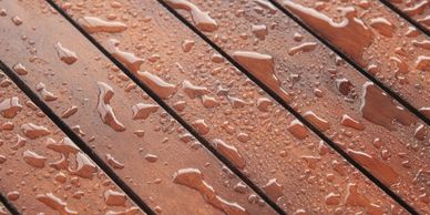Wooden surface with water droplets after rain.