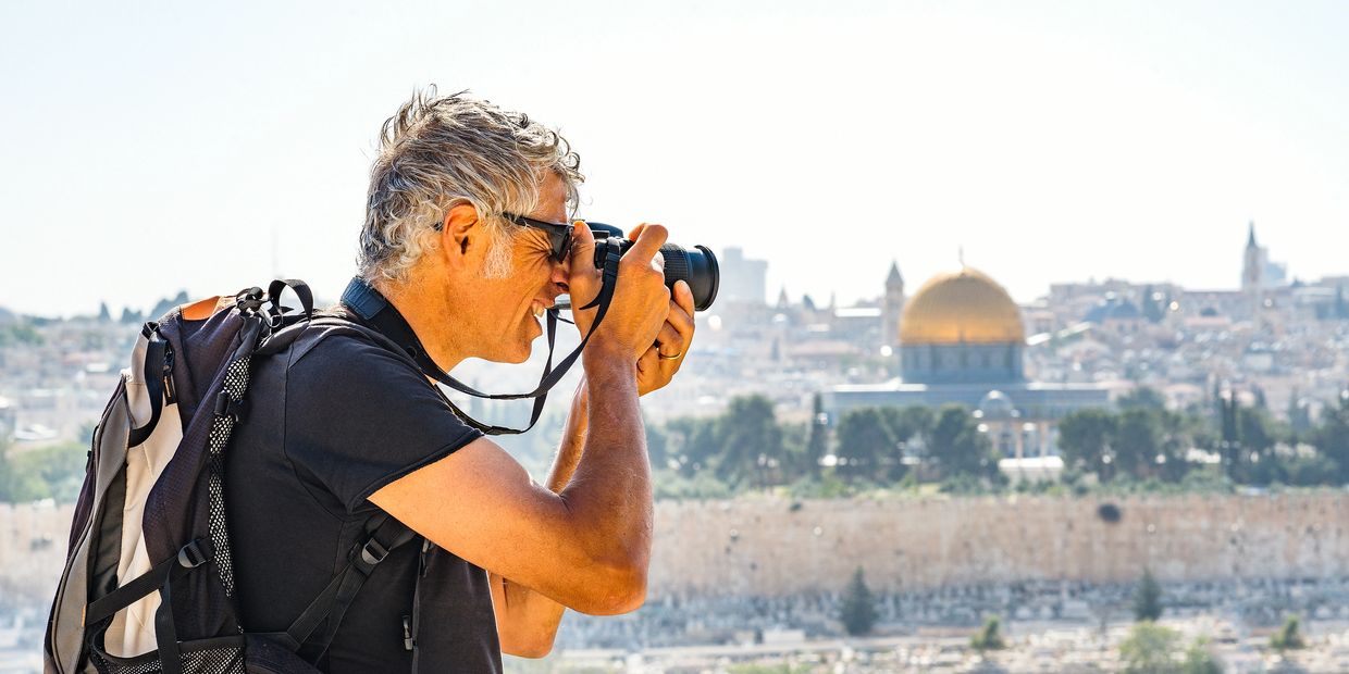 A tourist photographing the Dome of the Rock in Jerusalem.