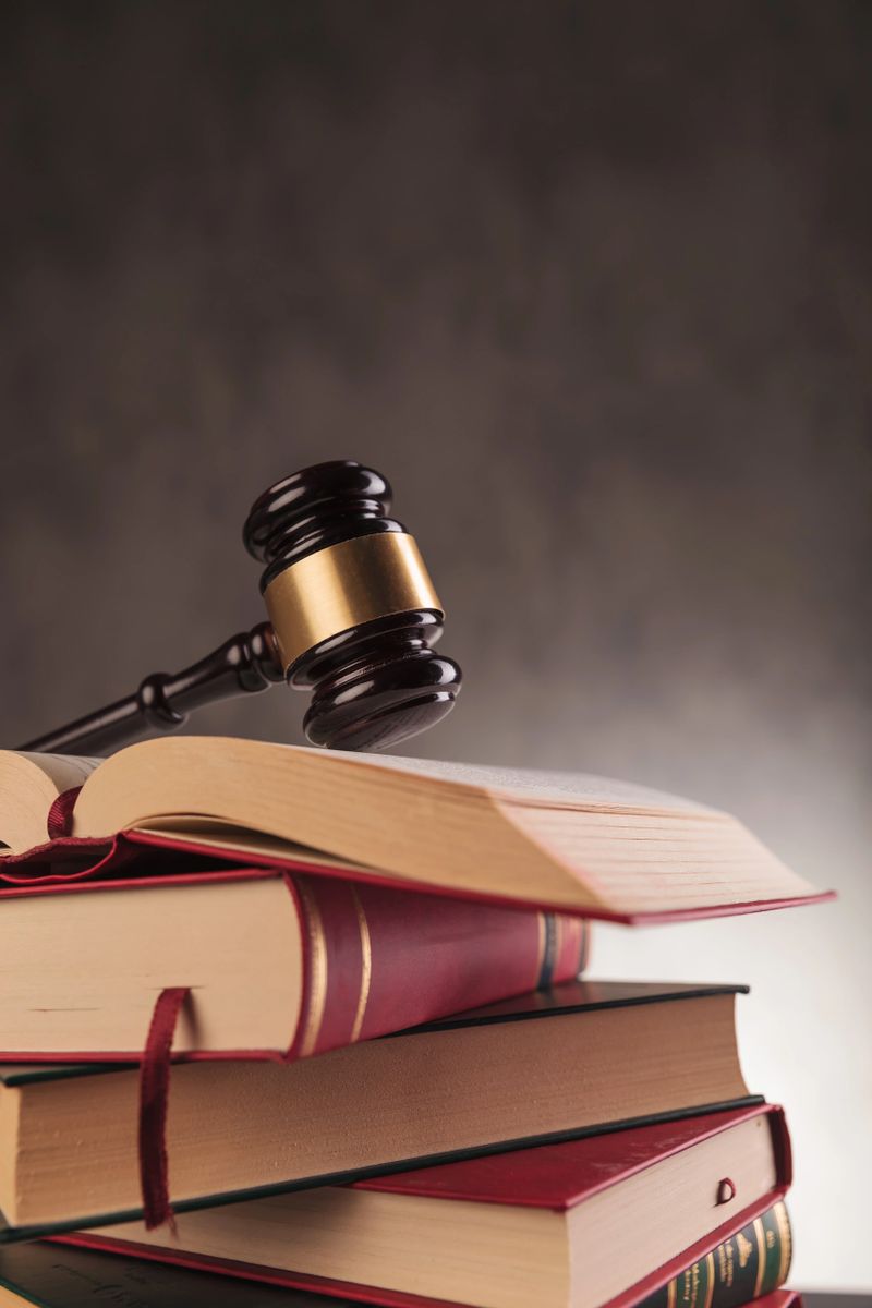 wooden hammer of a judge on a pile of books, studying law concept