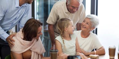 Family celebrating a young girl's birthday with cake and smiles.